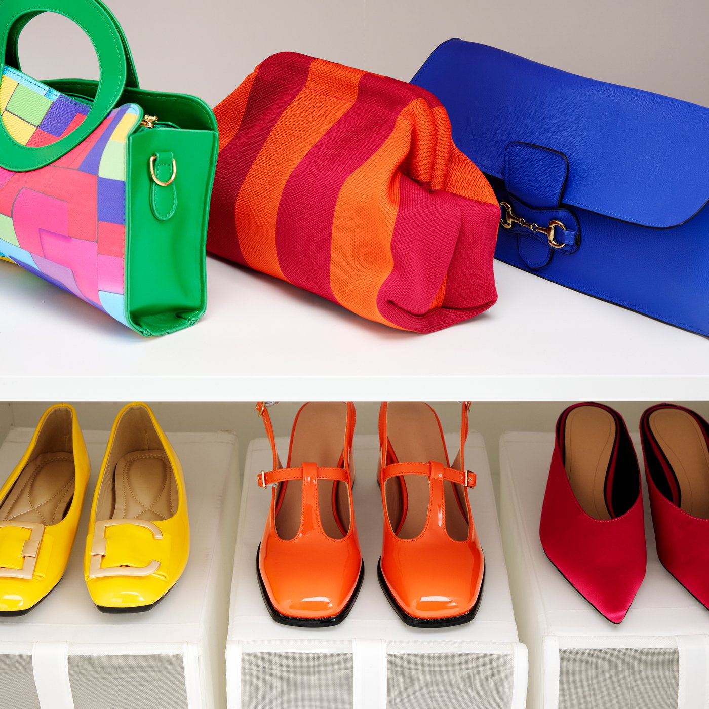 The inside of a white LASTARE wardrobe. On the shelves, a display of colourful handbags and women’s shoes.