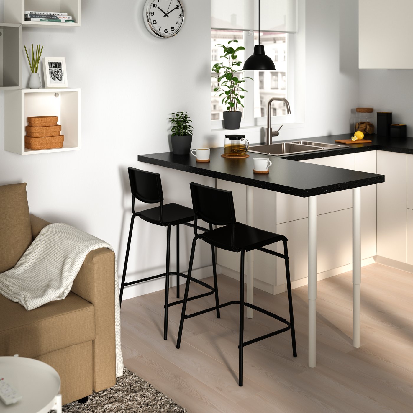 A counter height black/black STIG bar stool with backrest in the kitchen