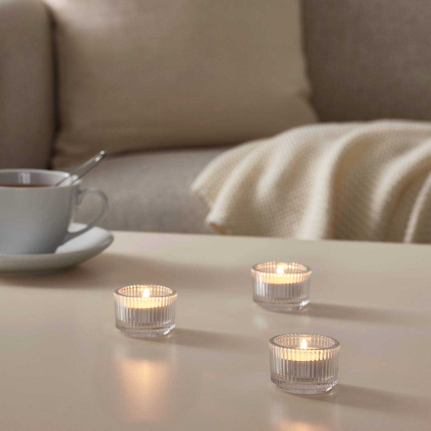 A clear glass FINSMAK tealight holder