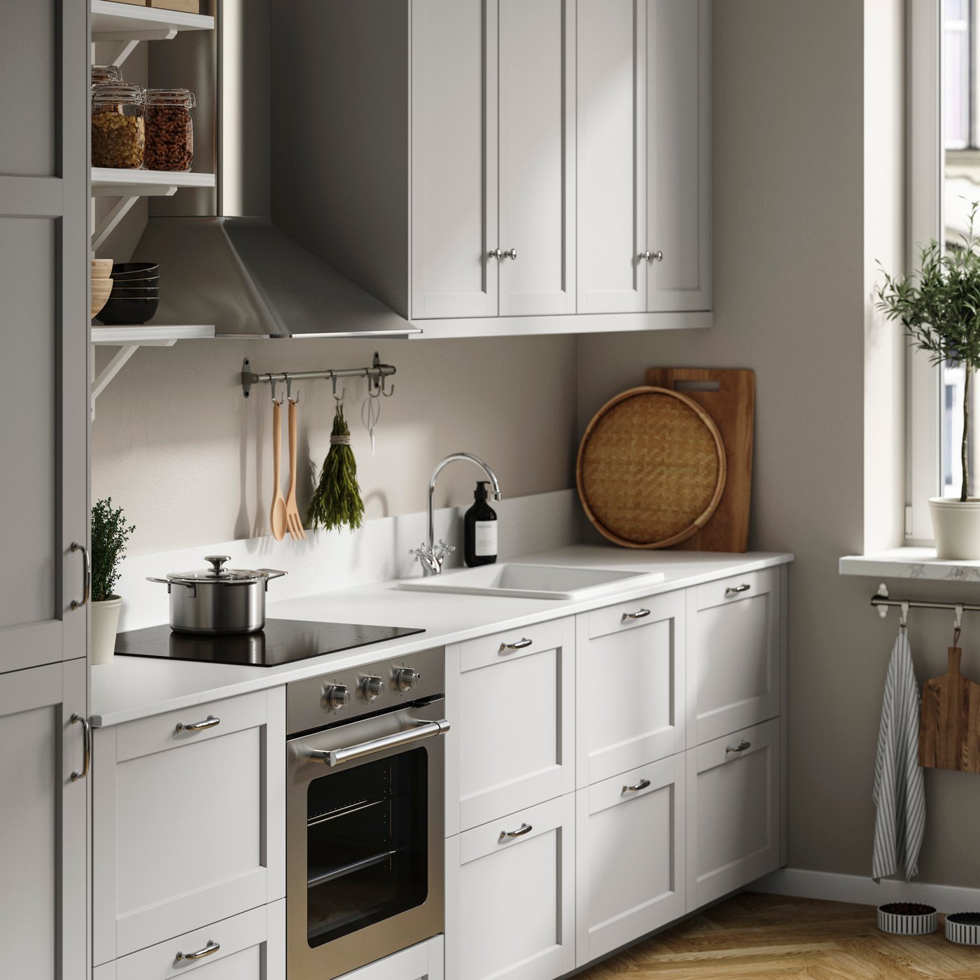 Une cuisine blanche avec un four et des accessoires beiges