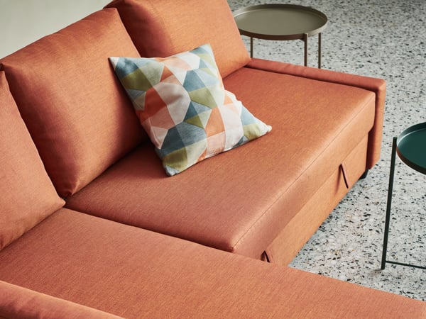 An orange/multicolour SVARTHÖ cushion cover