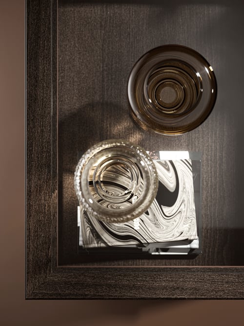 Overhead shot of the corner of a brown IDANÄS coffee table on which are two KONSTFULL vases, one set on notebooks.