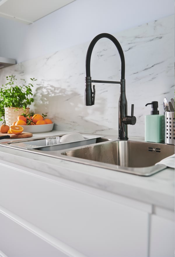 VIMMERN kitchen mixer tap/handspray on a white countertop, under a stainless steel KUNGSFORS rail with hooks and a container.