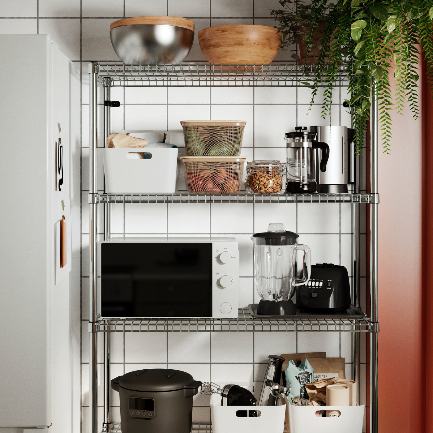 A well-organised OMAR shelving unit containing a microwave oven, a blender, an electric kettle and various boxes.