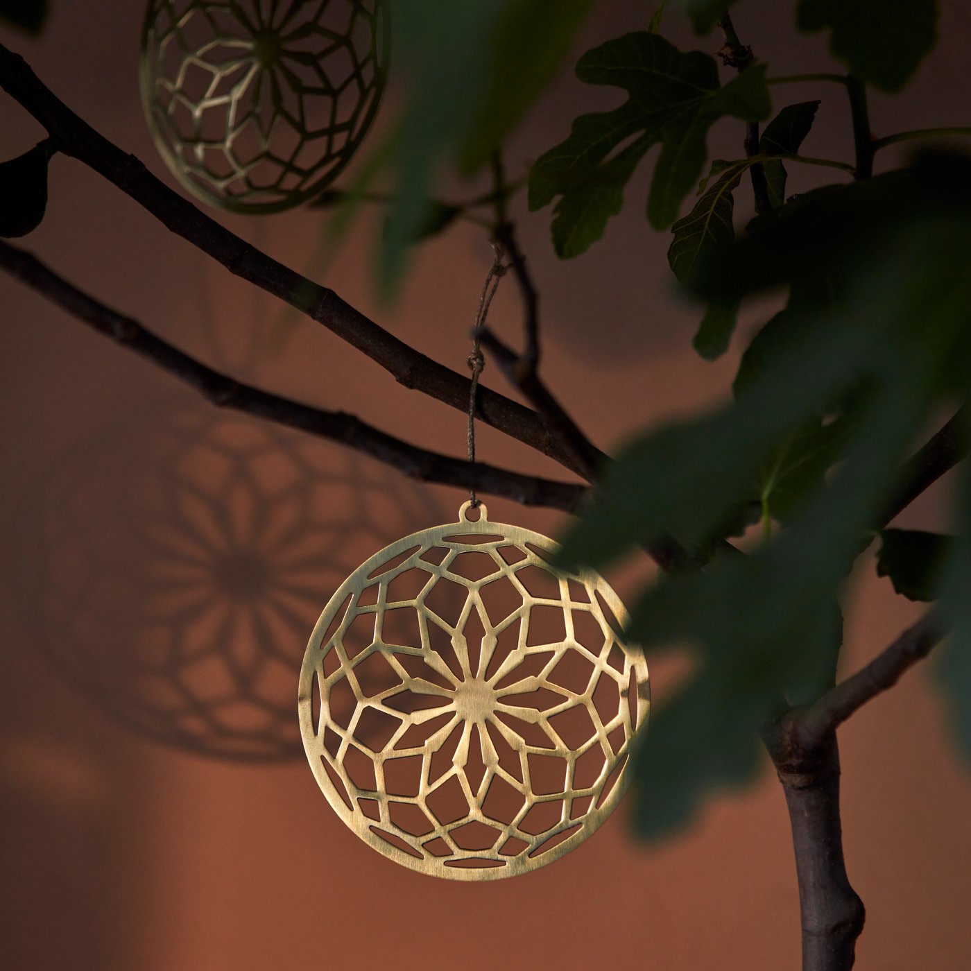 A gold-colour GOKVÄLLÅ hanging decoration.