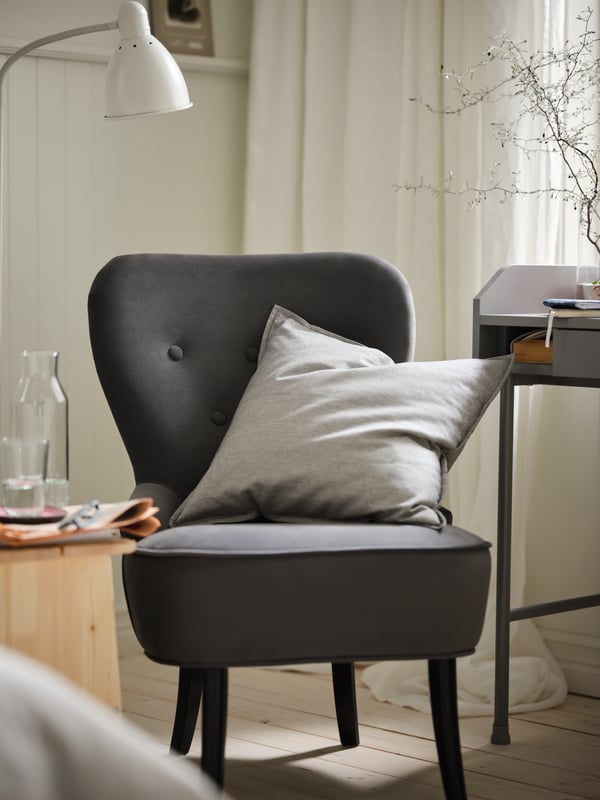 A white LERSTA floor/reading lamp in the bedroom