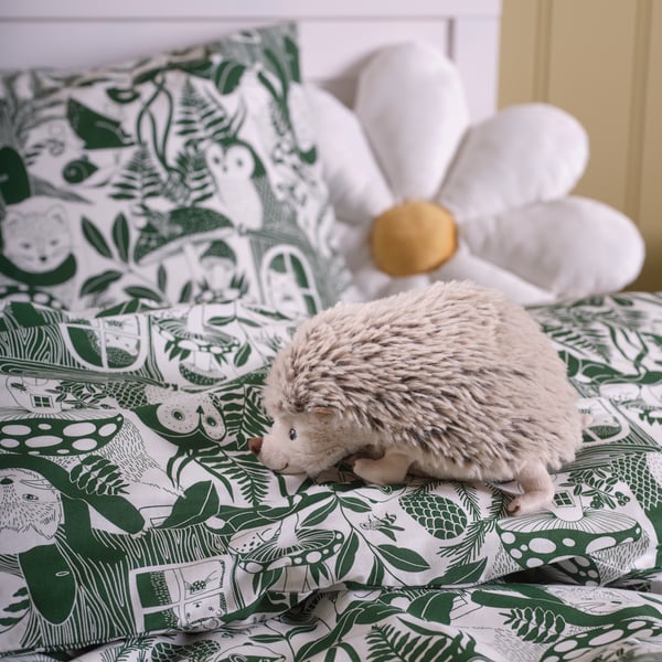 A hedgehog/beige SKOGSDUVA soft toy in the childrens room