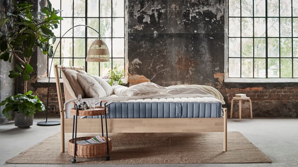 A firm/light blue VALEVÅG pocket sprung mattress