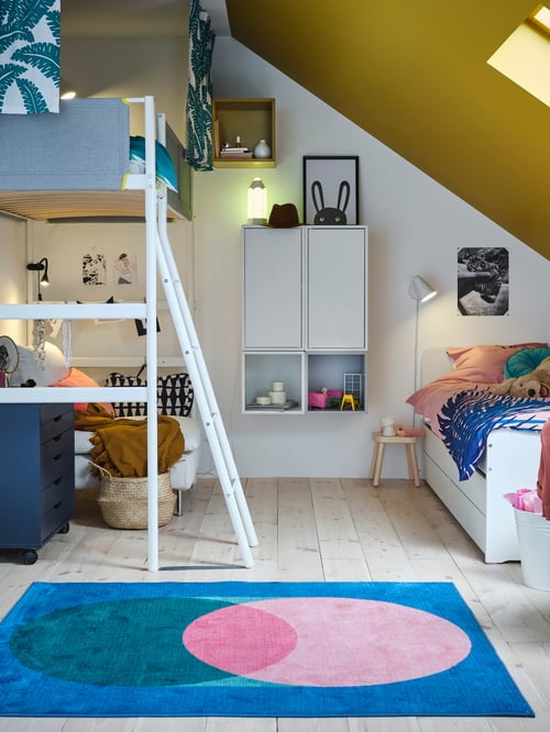 Children’s bedroom with loft bed frame, rug, drawer unit, cabinet with door, basket, child’s stool, bed frame with underbed.