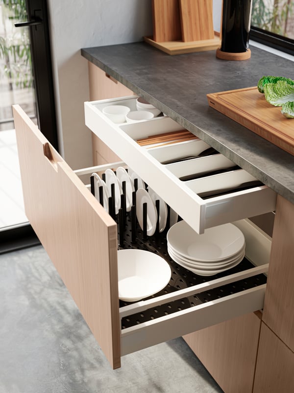 Close up of kitchen drawers with FRÖJERED fronts in light bamboo