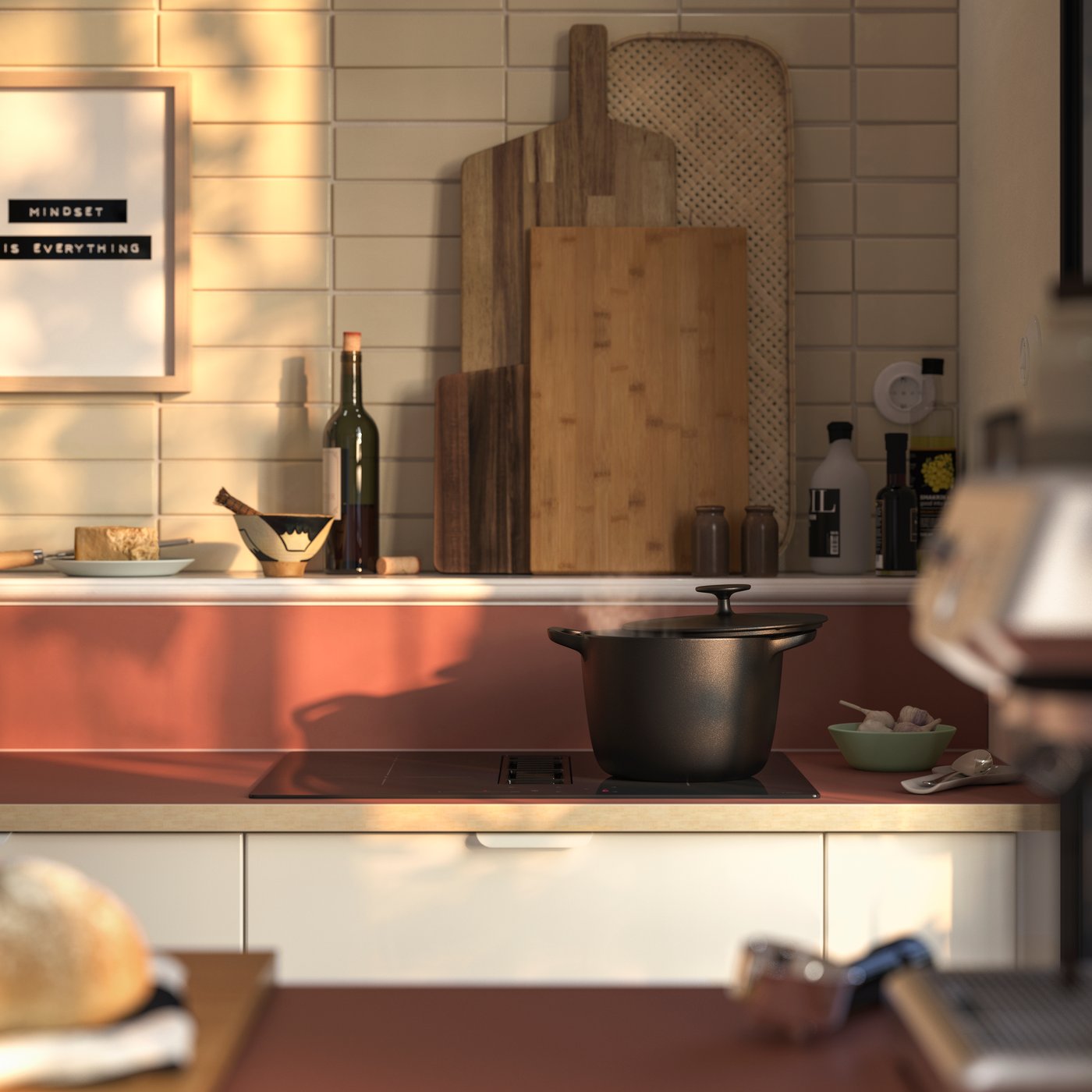 A minimalist kitchen featuring a grey countertop with a black induction hob, a wooden cutting board, and various bottles.