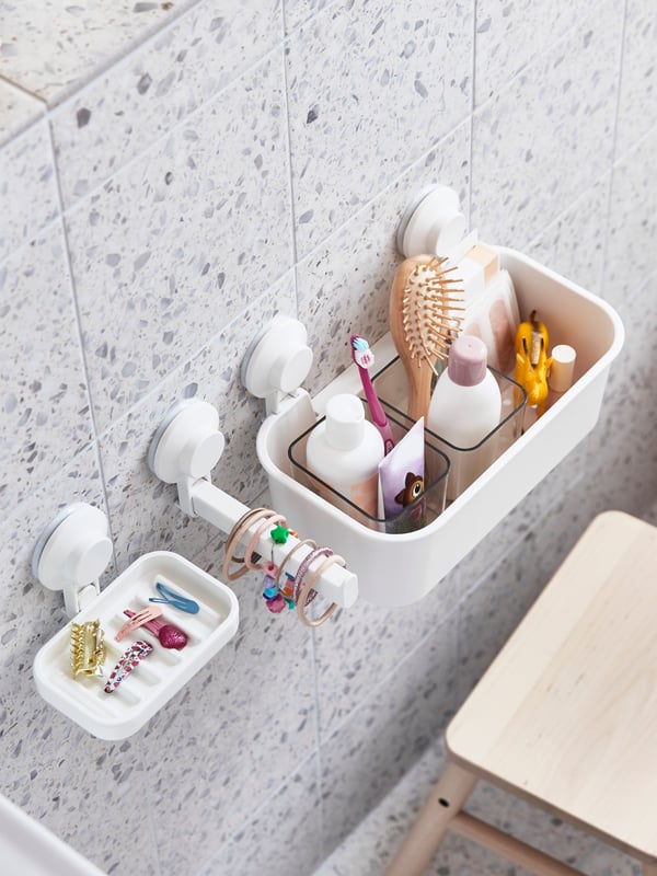 A white TISKEN basket with suction cup in the bathroom