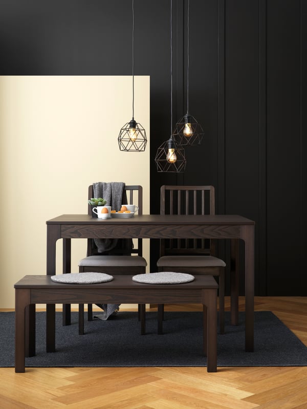 A dark grey MORUM rug flatwoven, in/outdoor in the dining room