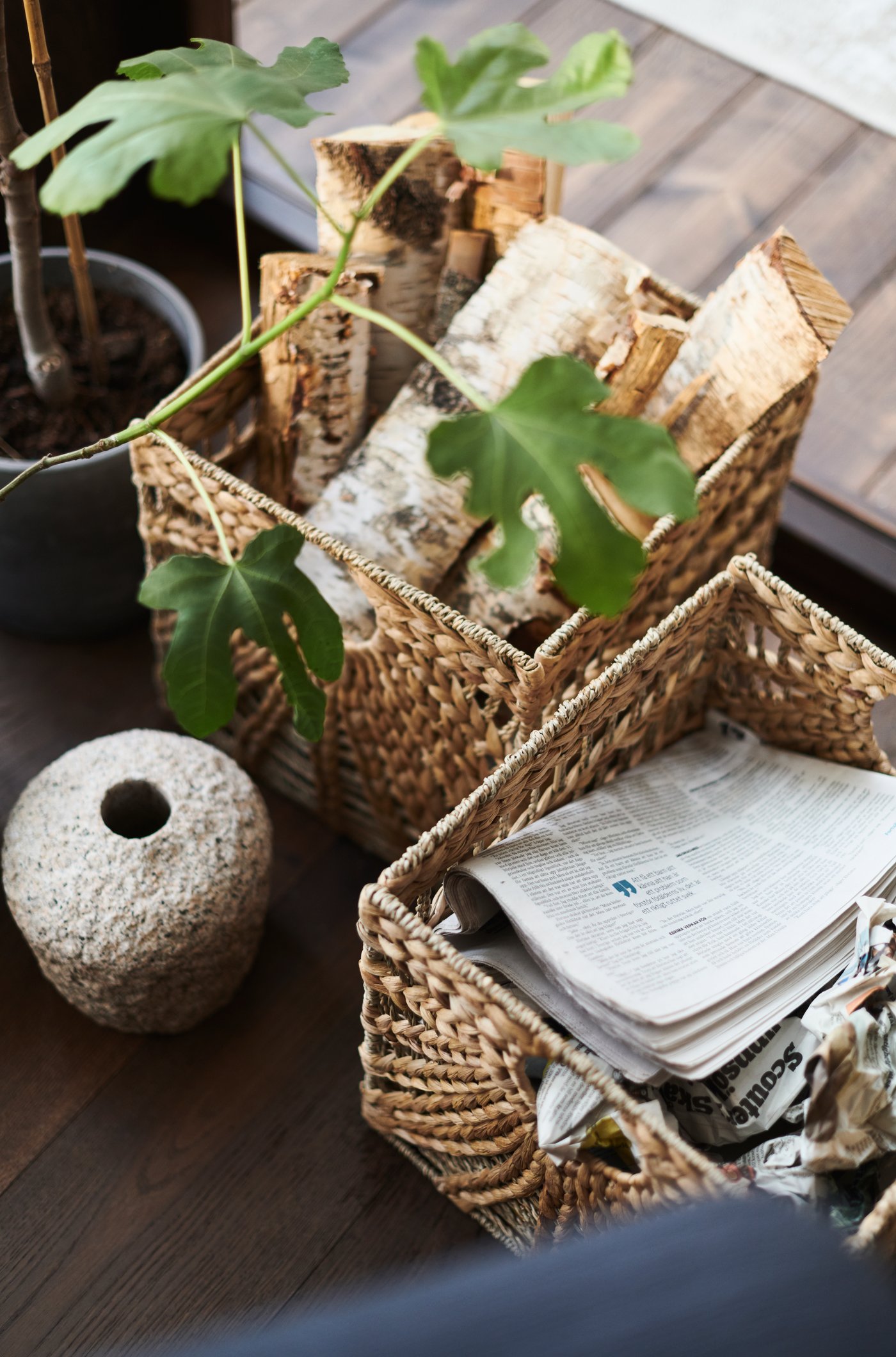 A natural water hyacinth/seagrass LUSTIGKURRE basket in the corner of the living room.
