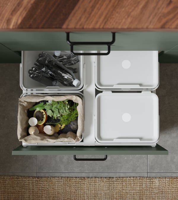 Garbage sorting from IKEA where a person has pulled out the boxes where you can see four different sorting boxes.