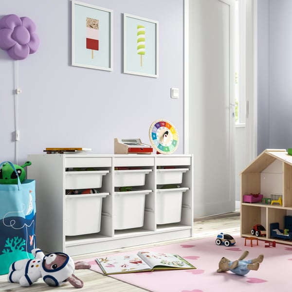A white/white TROFAST storage combination with boxes in the childrens room