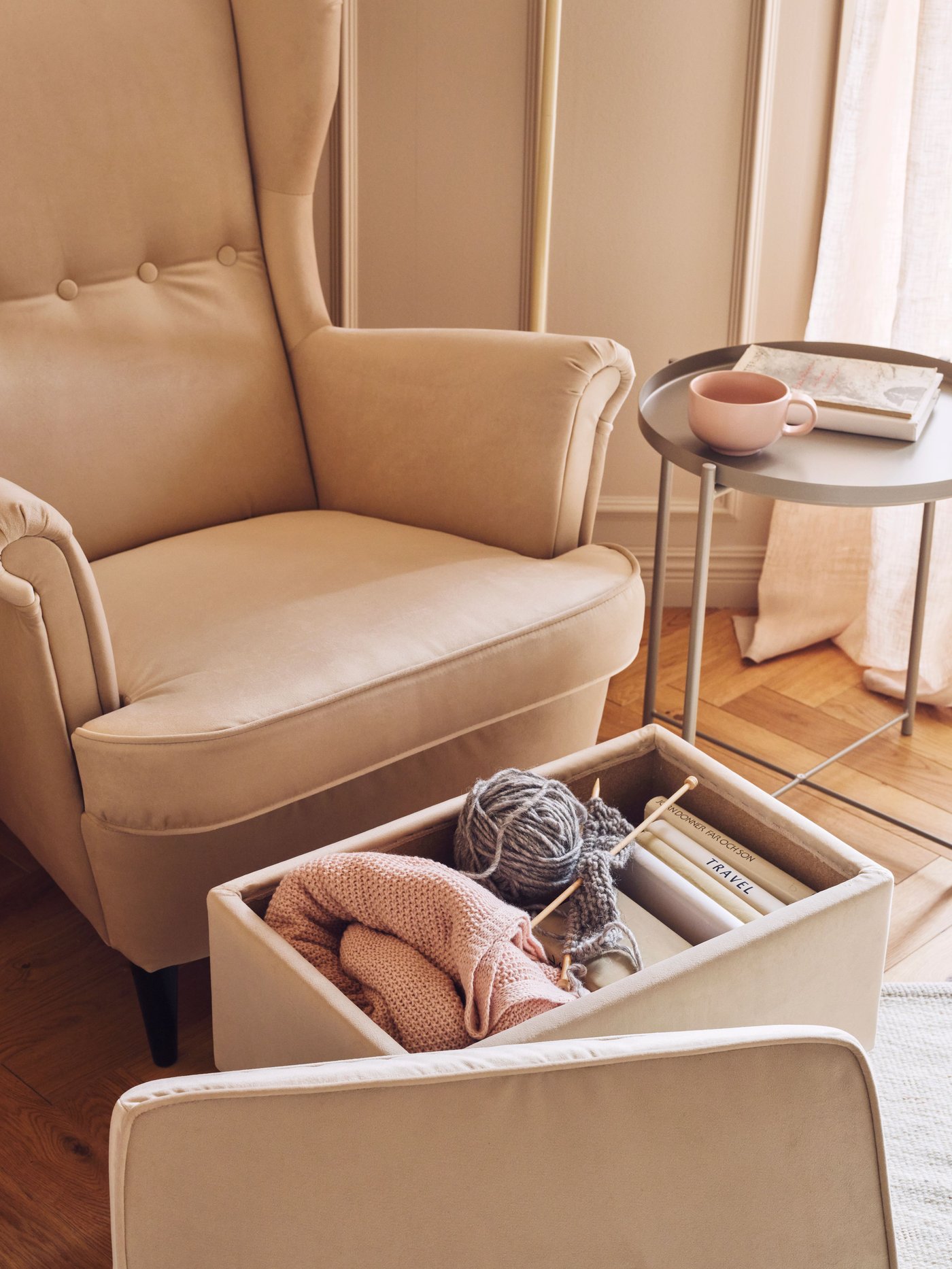 A Tommaboda deep beige STRANDMON wing chair with footstool in the living room