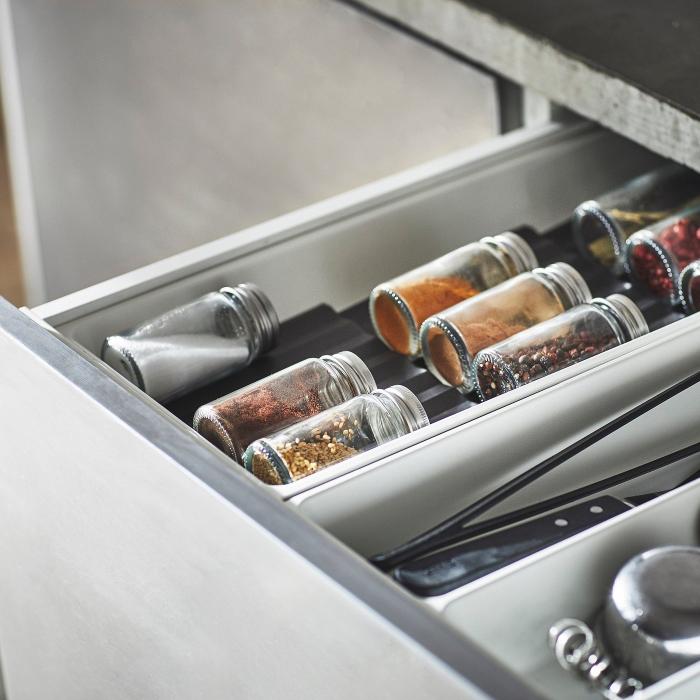 A clear glass/stainless steel GULDFISK spice jar