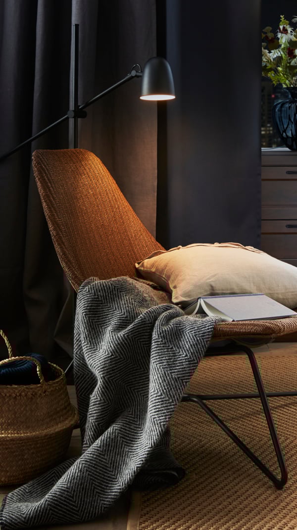 A black SKURUP floor/reading lamp in the bedroom