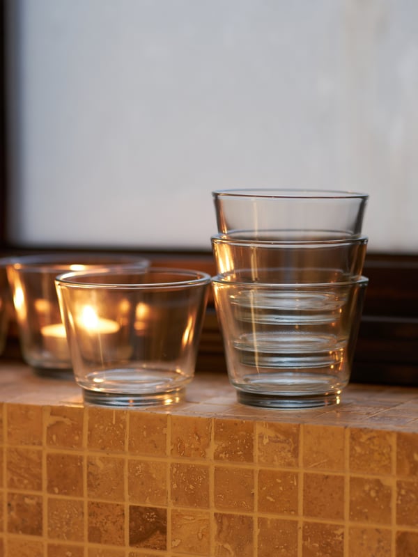 GALEJ tealight holders stacked on top of each other with an ADLAD scented tealight glowing in the background.