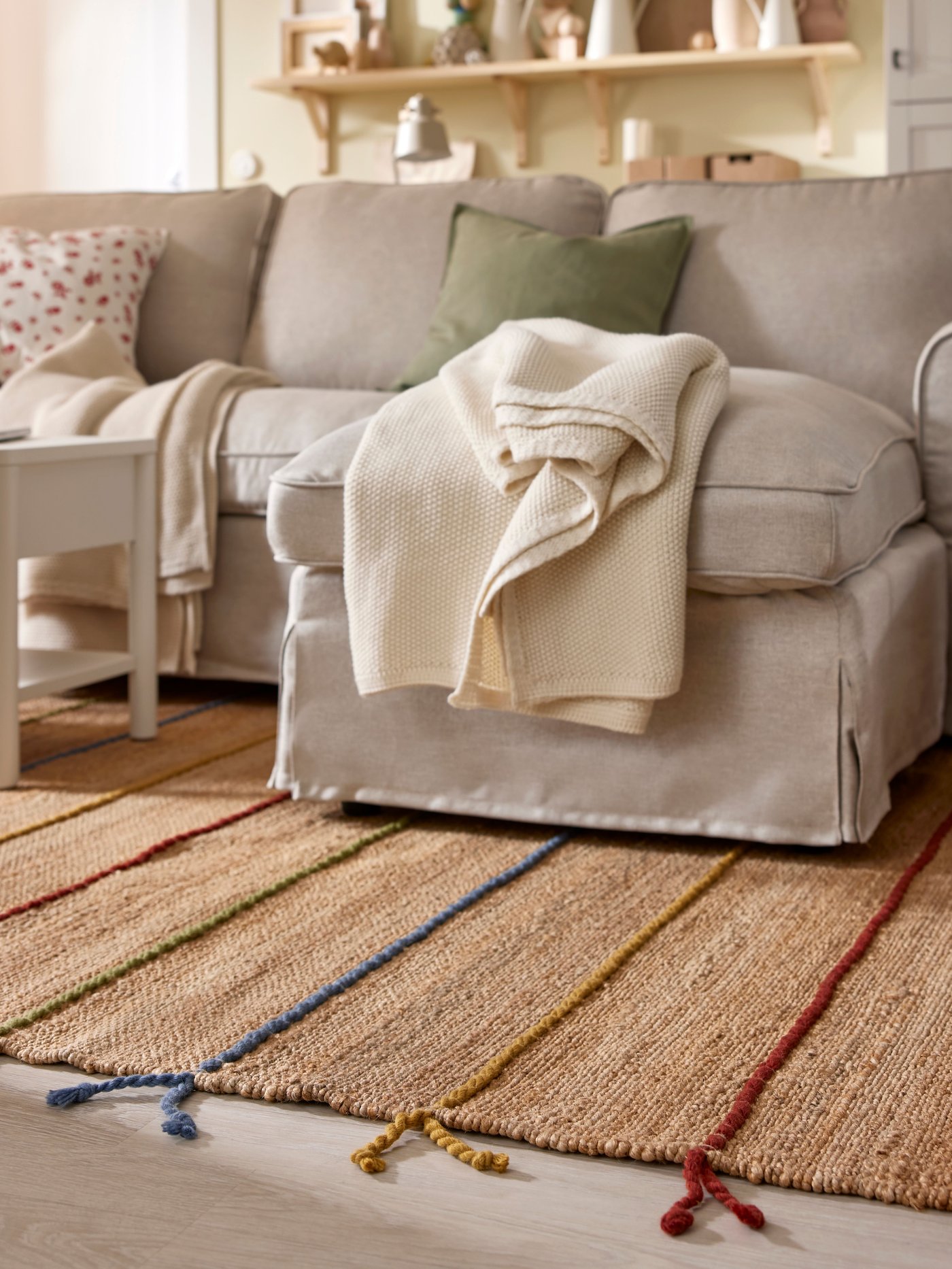 A Kilanda light beige EKTORP 3-seat sofa with chaise longue in the living room