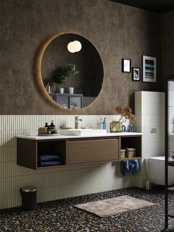 A green-brown KONSTFULL vase in the bathroom