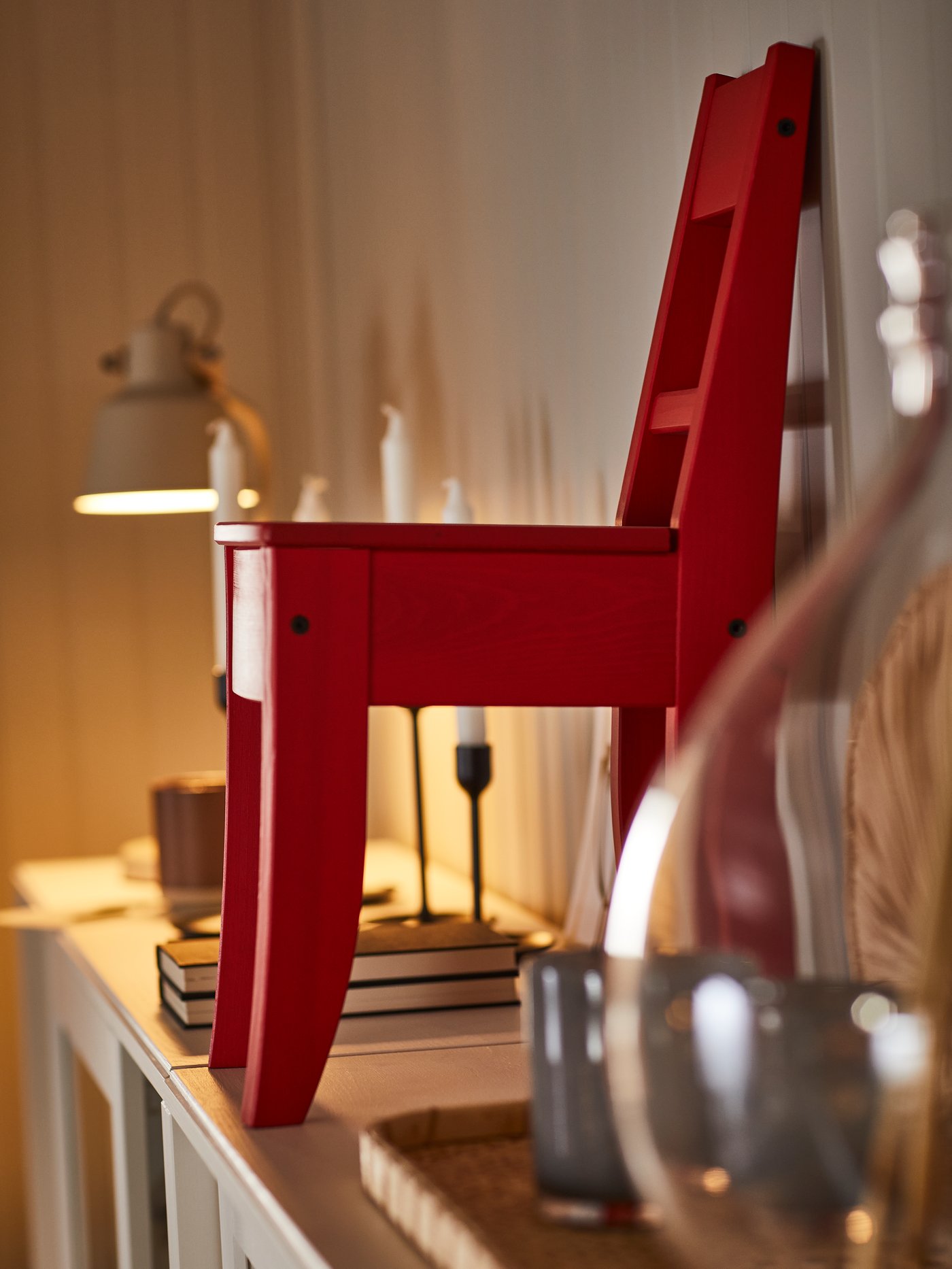 Une chaise décorative rouge sur un buffet.