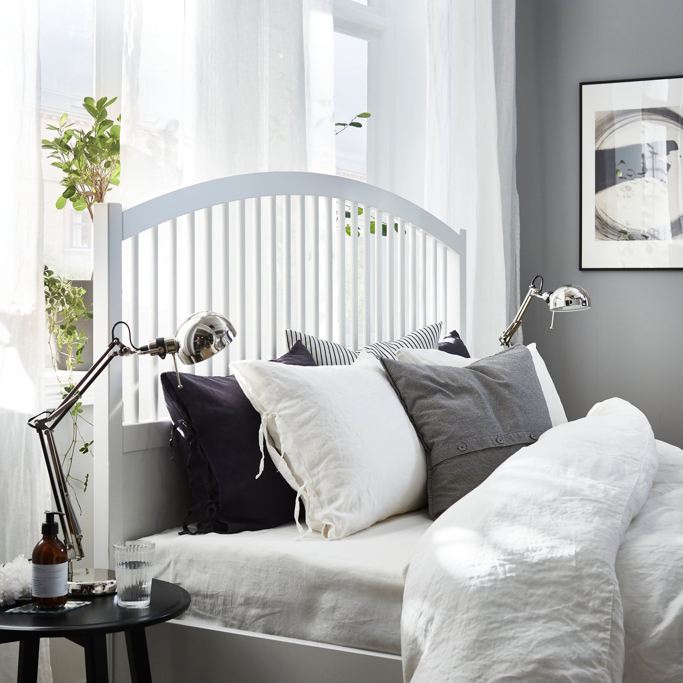 A black KRAGSTA nest of tables in the bedroom