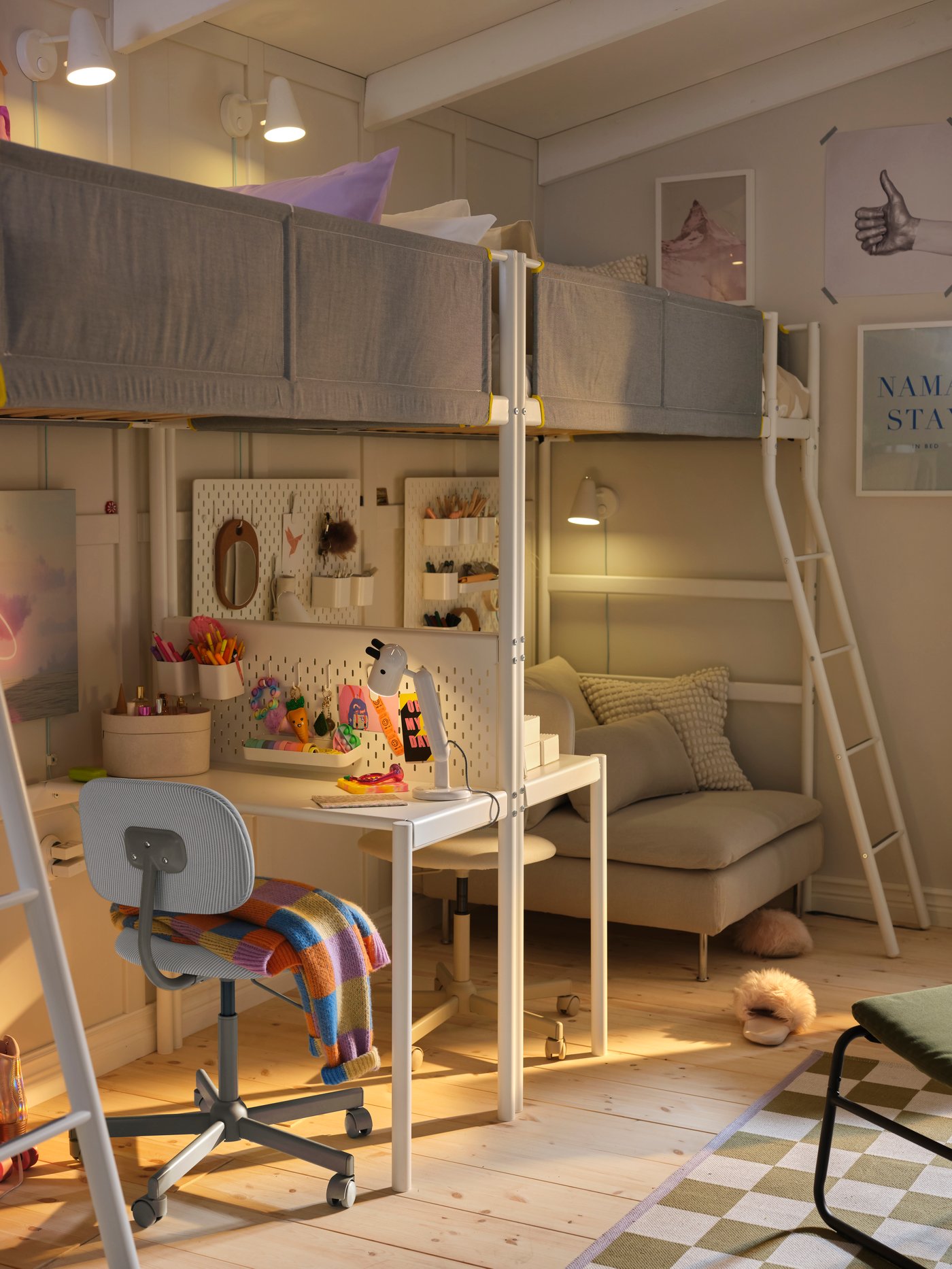 Two VITVAL loft beds and desk top placed end-to-end along a beige bedroom wall with a white/grey swivel chair underneath.