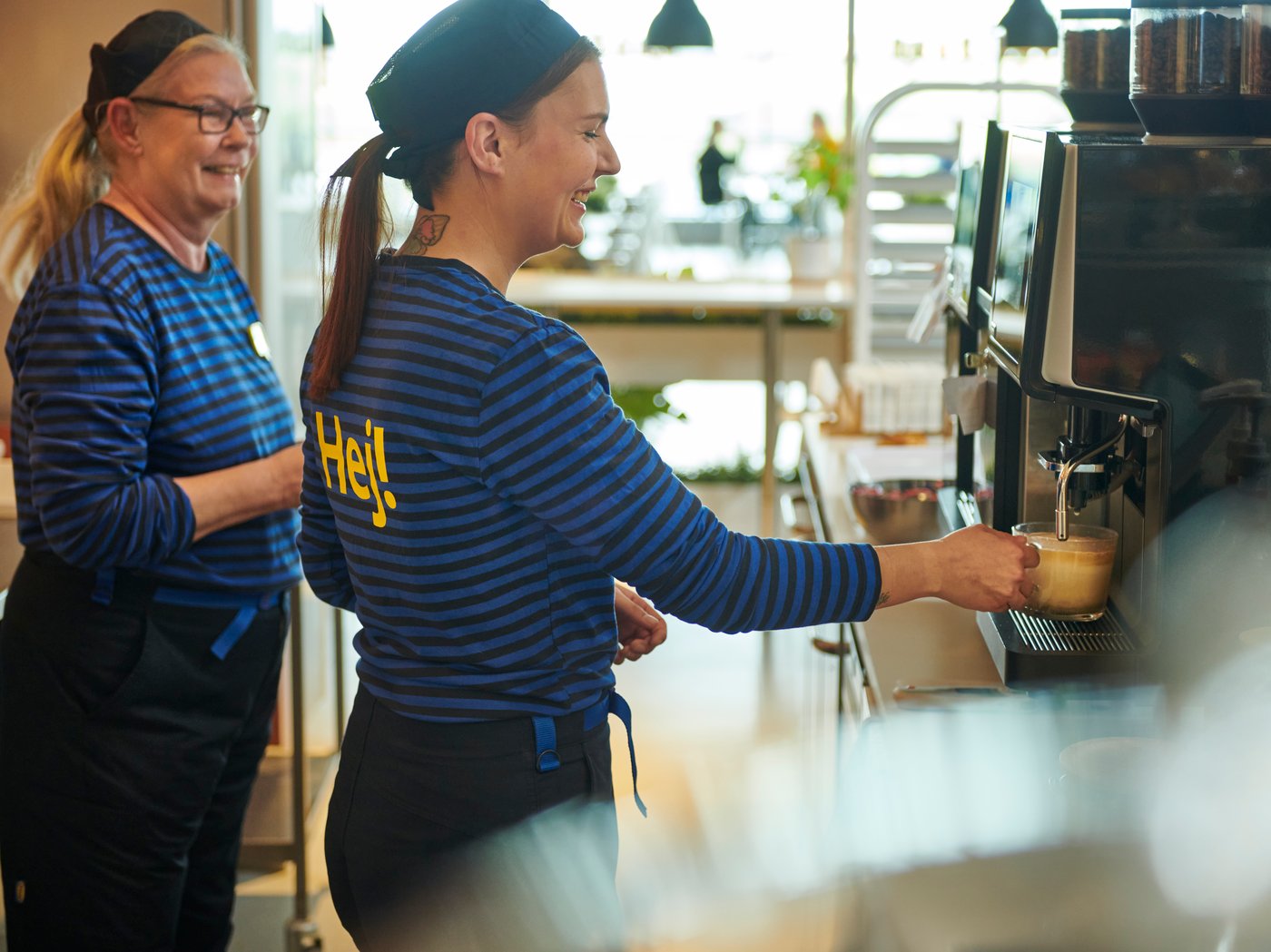 Two IKEA co-workers getting coffee.