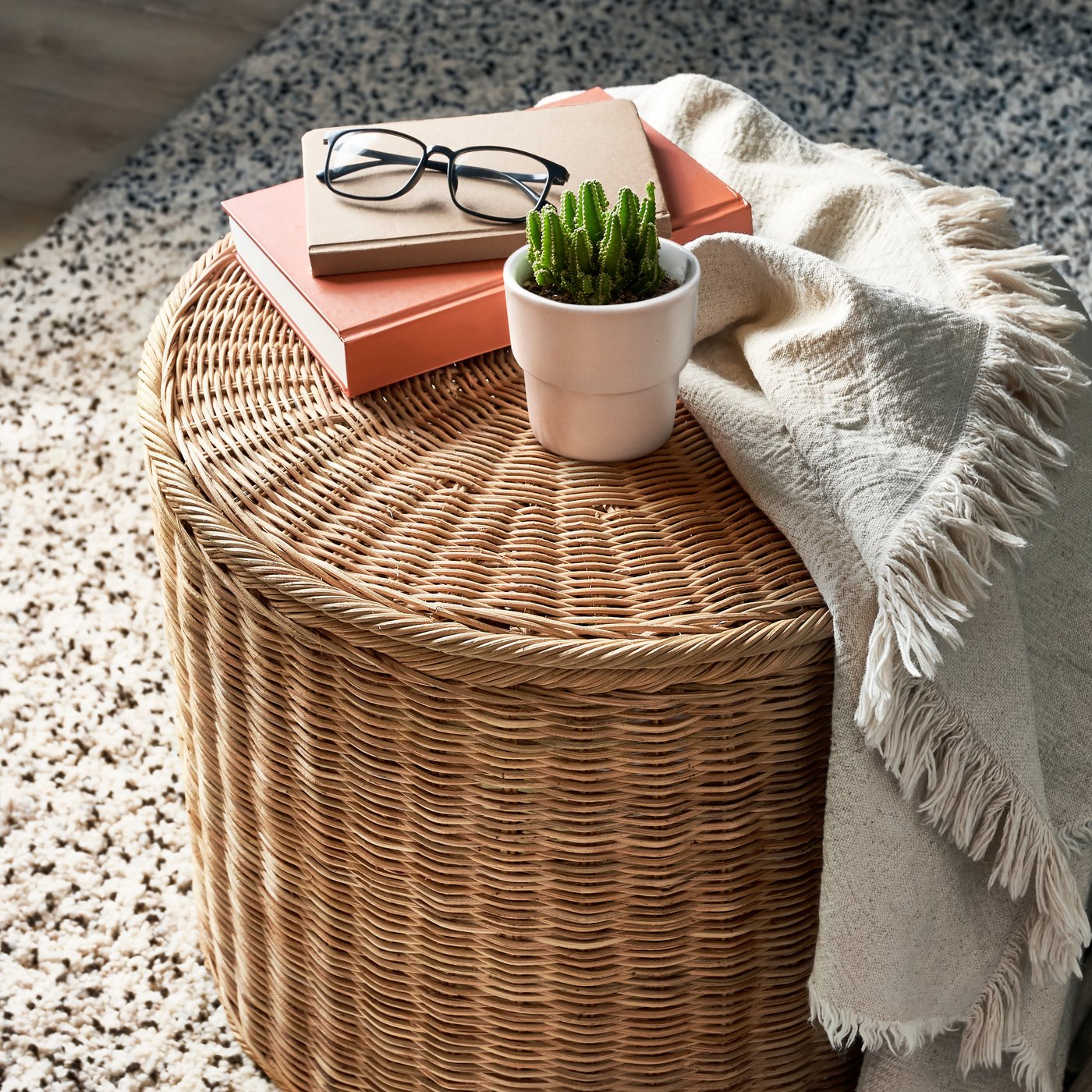 A handmade rattan TOLKNING pouffe with storage