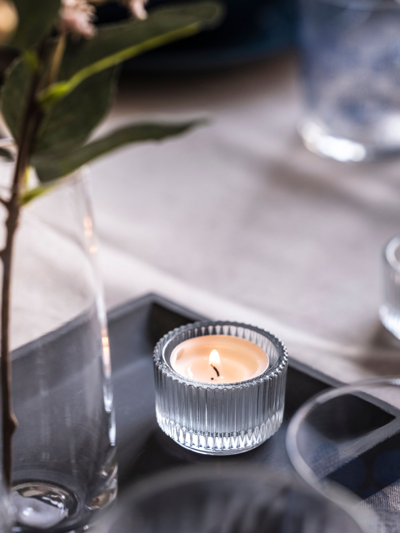 A GLIMMA unscented candle in metal cup