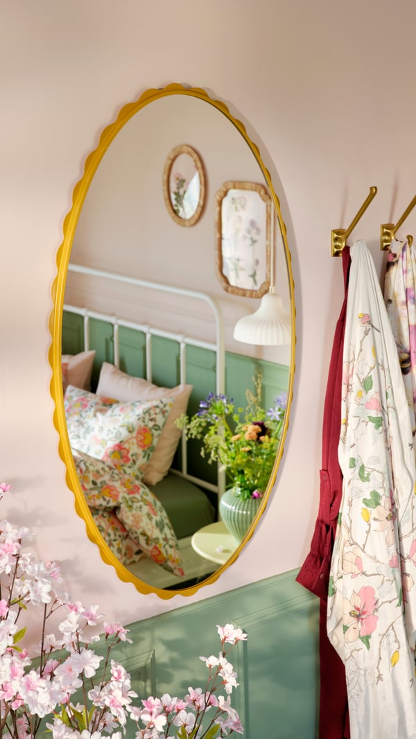 An in/outdoor/pale yellow TÅNEBRO side table in the bedroom