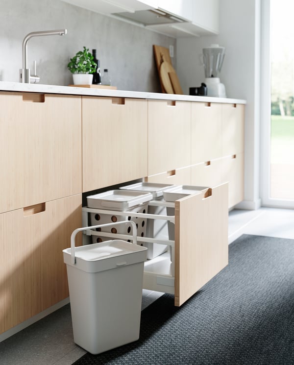 A dark grey MORUM rug flatwoven, in/outdoor in the kitchen