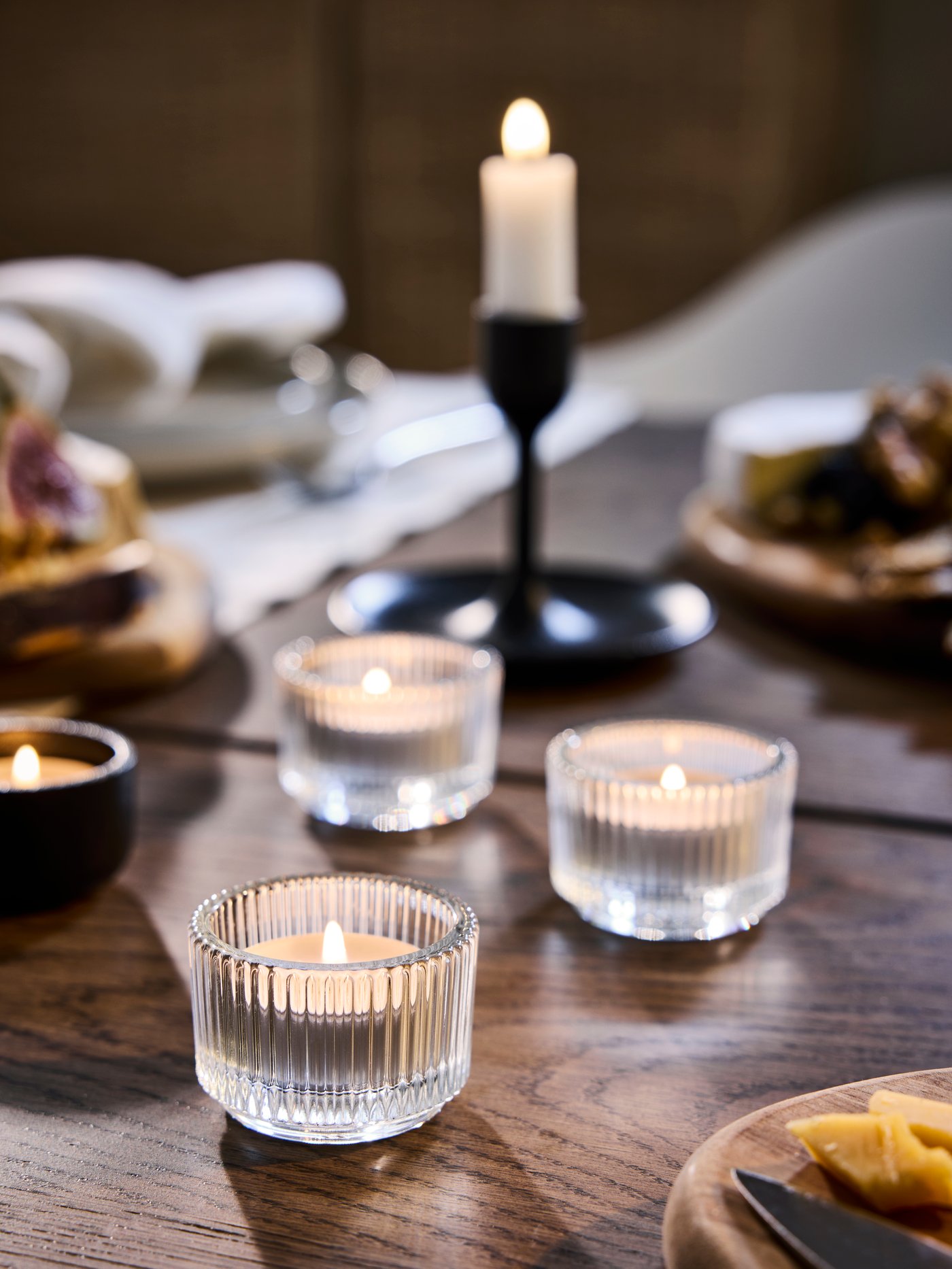 A clear glass FINSMAK tealight holder