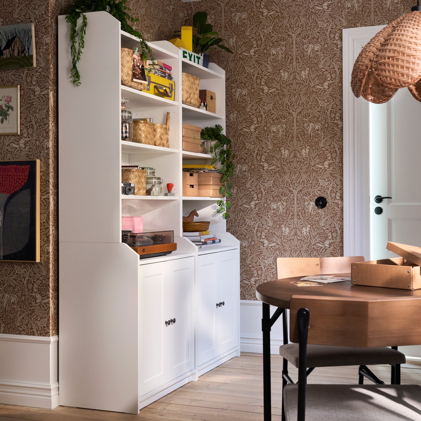 A room featuring HAUGA high cabinet with 2 doors in white, decorated with jars, boxes, plants and books on shelves.