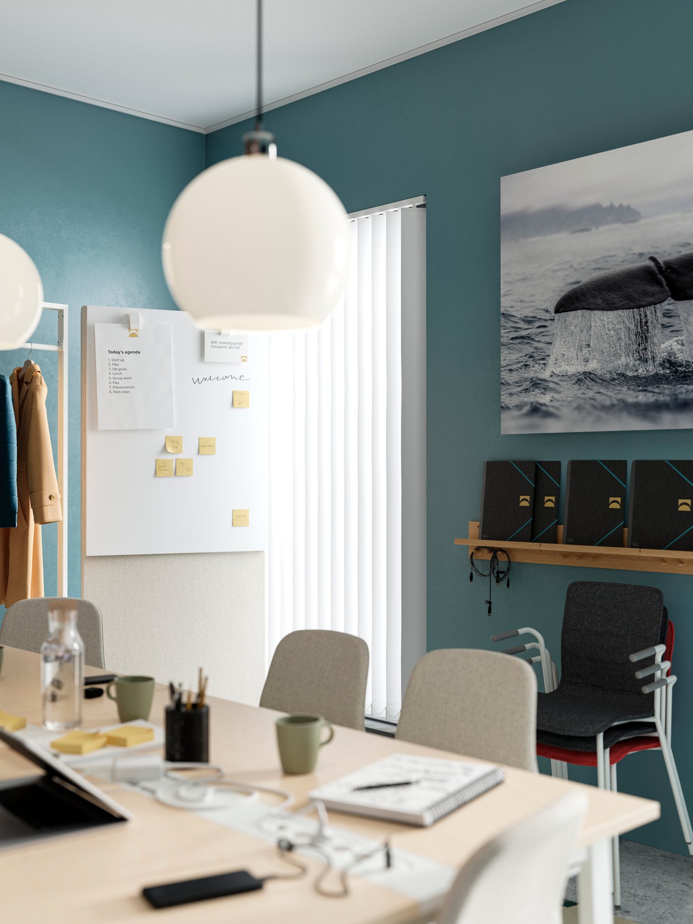 By a meeting room table is a whiteboard on a MITTZON frame with castors and acoustic screen that has sticky notes on it.
