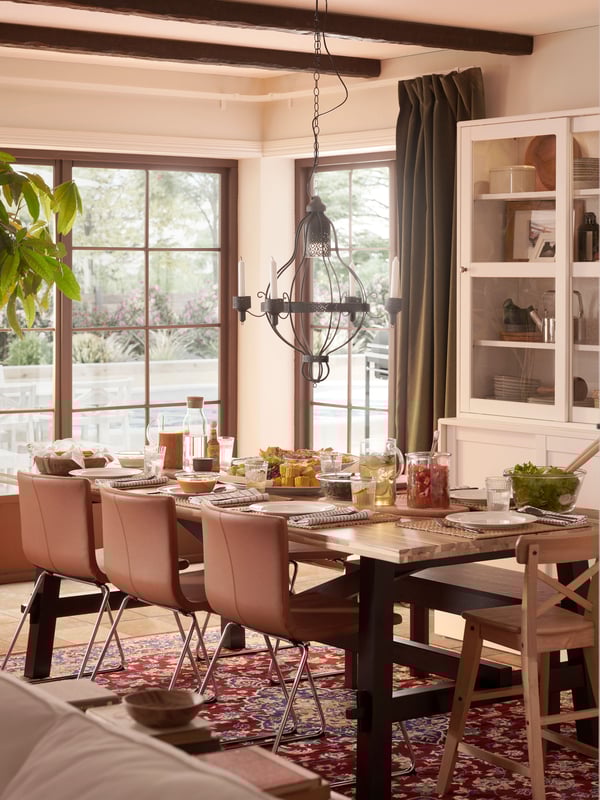 An acacia/black SKOGSTA dining table in the dining room