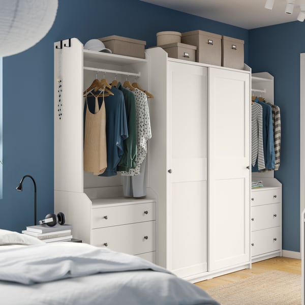 A white HAUGA open wardrobe with 3 drawers