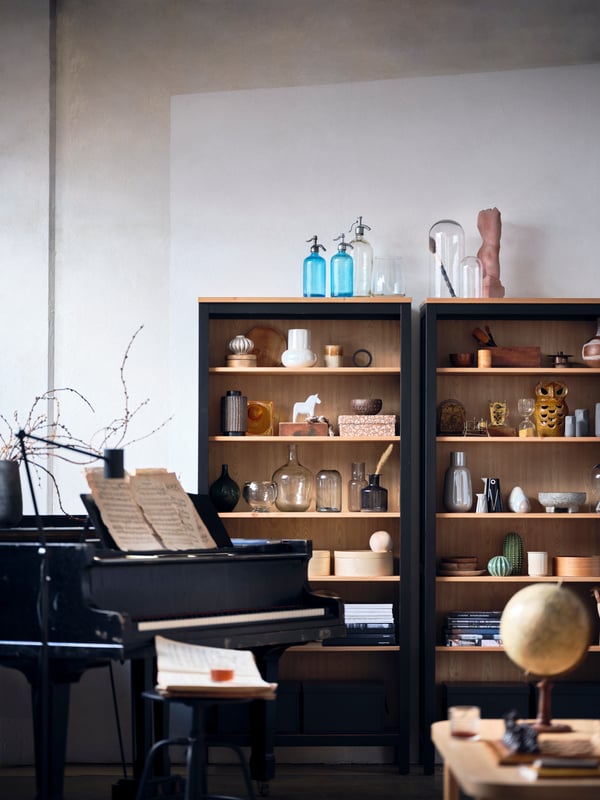 A HEMNES cabinet filled with ceramics, books, storage boxes and other objects.