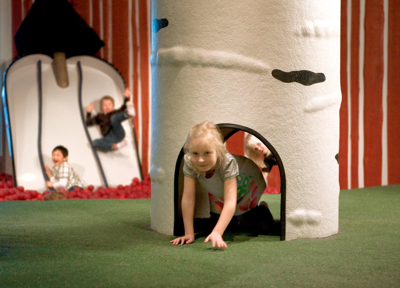 A child playing in an IKEA Småland play area.