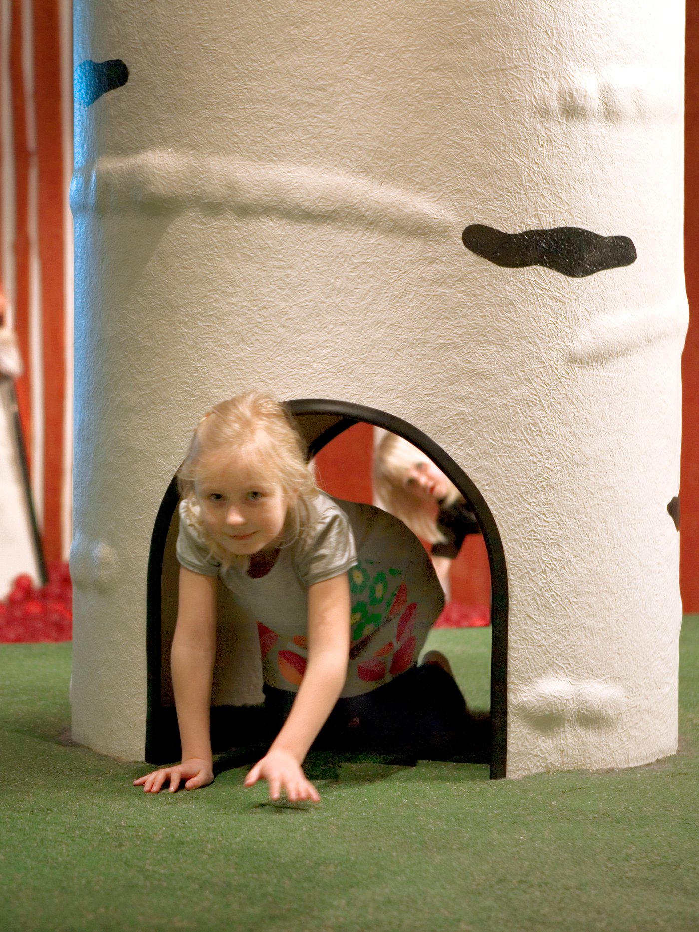 A child playing in an IKEA Småland play area.