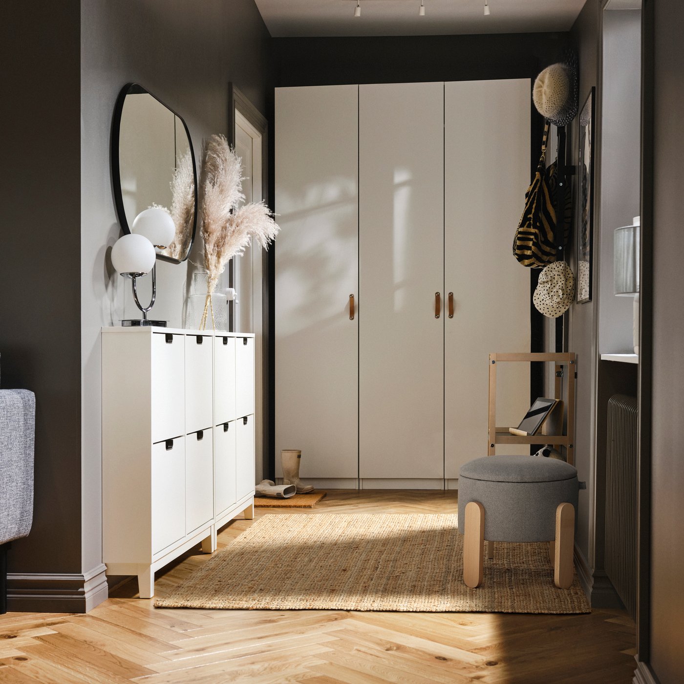 A tidy hallway with a white shoe cabinet, a white wardrobe, and a LOHAL rug on the floor.