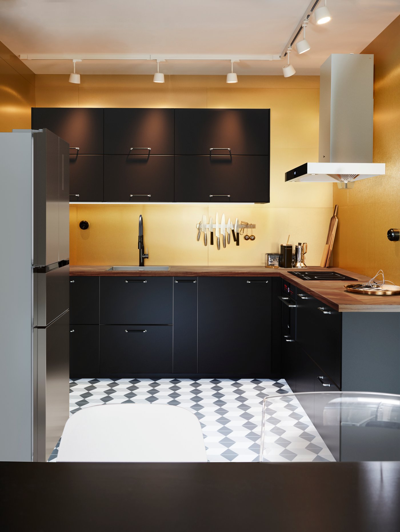 A brushed black metal GAMLESJÖN dual-control kitchen mixer tap in the kitchen