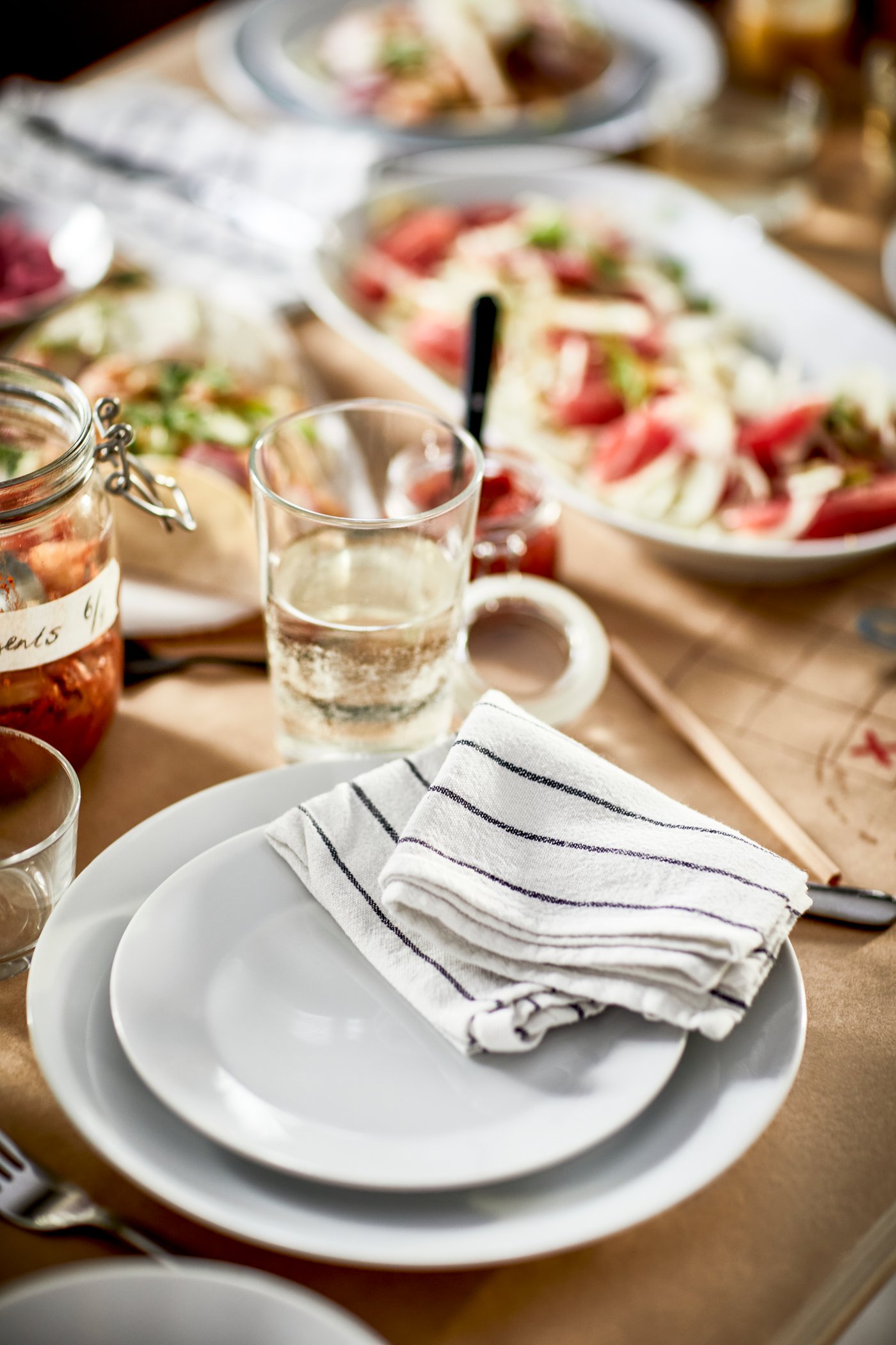 A white/dark grey/patterned RINNIG tea towel