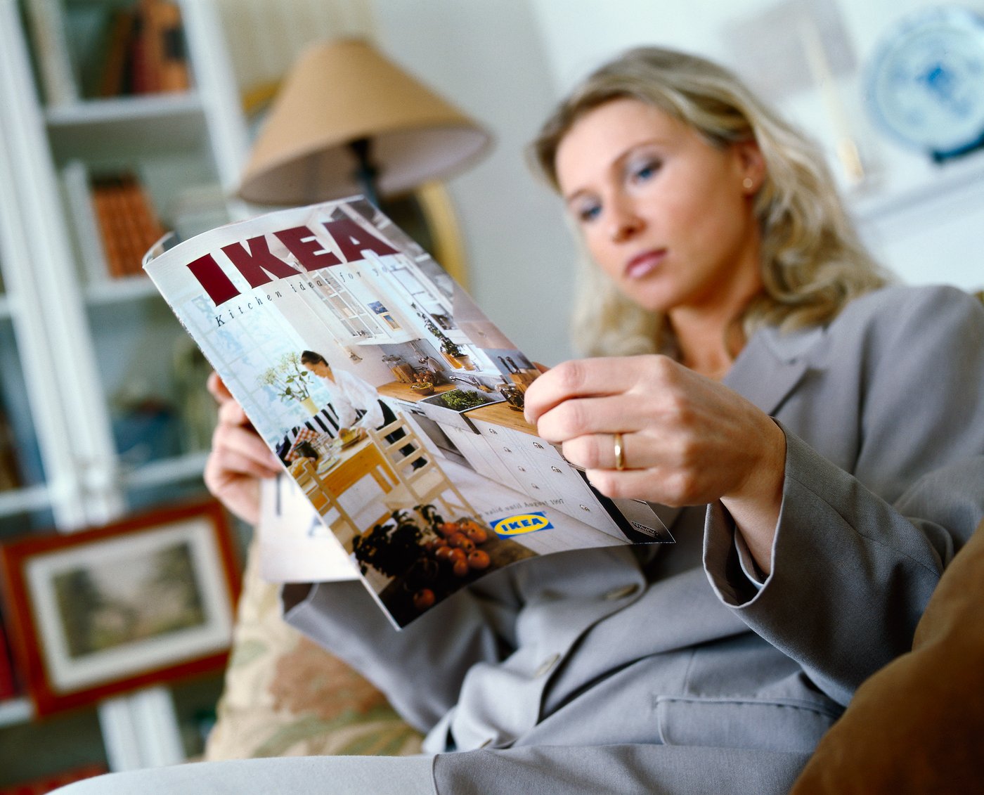Woman reading an IKEA brochure