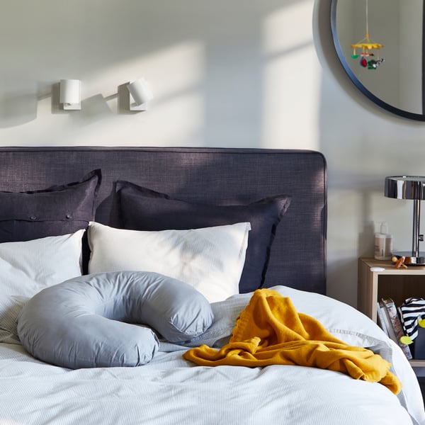 A grey LEN nursing pillow in the bedroom