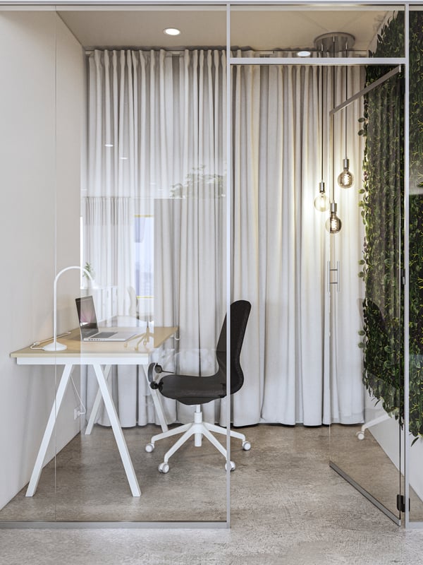 TROTTEN beige/white desk shown in a small room with a glass door, white thick curtains and a black chair.