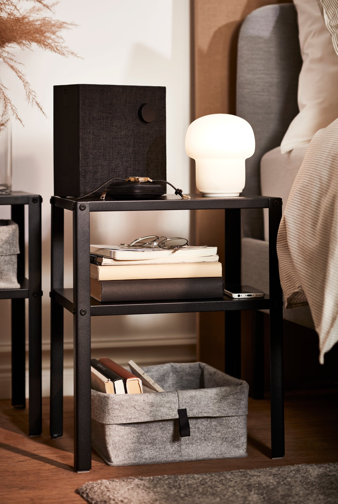 A black KNARREVIK bedside table in the bedroom