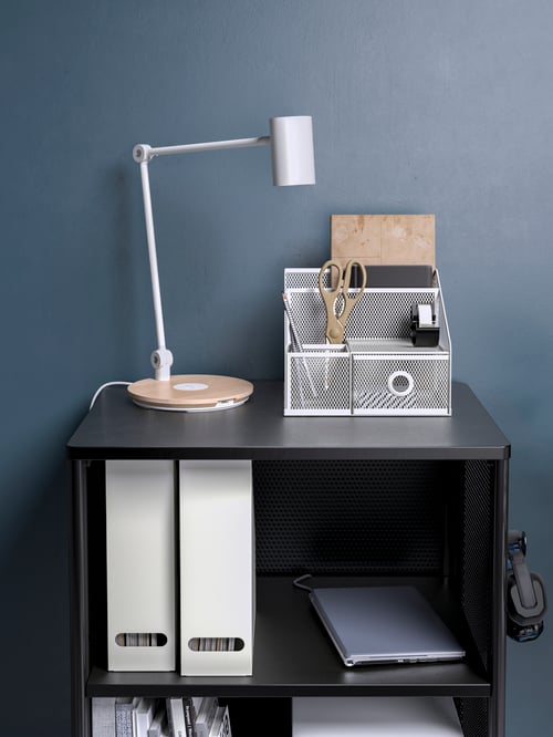 Workspace with storage unit with castors, desk organiser, pencils, scissors, work lamp with LED, magazine files, laptop.